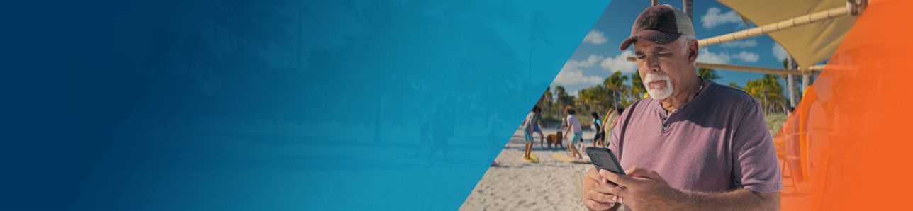 Potential OPDIVO® (nivolumab) user on the beach and using his phone.