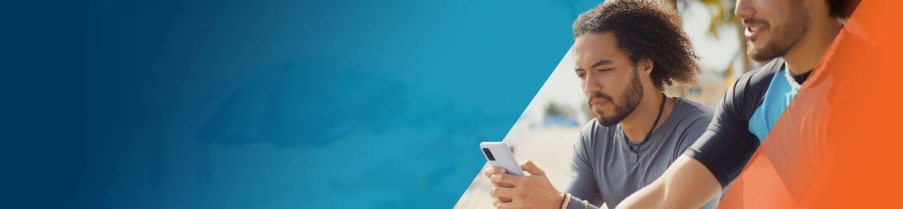 Potential OPDIVO® (nivolumab) user on his phone, sitting next to his friend on the beach.