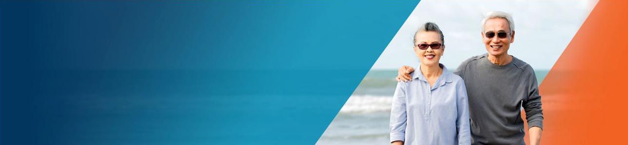 Potential OPDIVO® (nivolumab) user and her husband standing on a beach.
